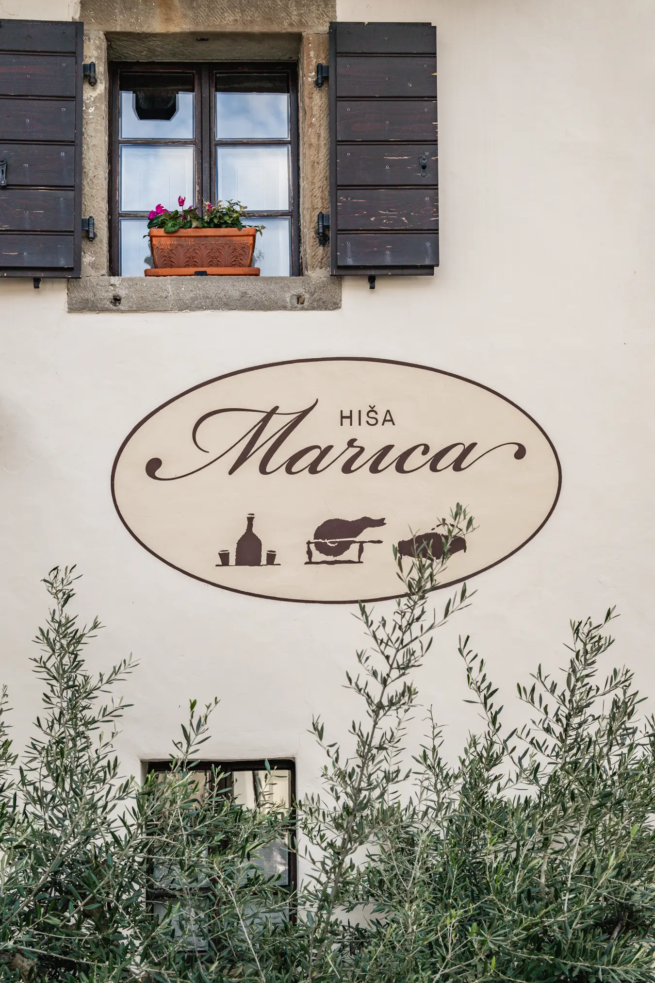 {"sl":"Stena stavbe s starinskim oknom, lon\u010dnico in napisom 'Hi\u0161a Marica' na znaku.","en":"","de":"","it":""}